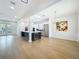 Spacious living room with a large island, modern chandelier, stainless steel appliances and an open layout at 217 W Bay St, Winter Garden, FL 34787