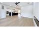 Open floor plan featuring a spacious living area with a kitchen, modern lighting, and beautiful hardwood flooring at 217 W Bay St, Winter Garden, FL 34787