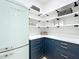 Pantry featuring a blue cabinet, white countertop, shelving and retro refrigerator at 217 W Bay St, Winter Garden, FL 34787