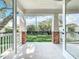 Charming covered patio with brick columns overlooking a well-manicured yard, accessible through glass doors at 217 W Bay St, Winter Garden, FL 34787