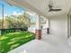 Inviting porch with brick columns, white railings, and a ceiling fan overlooking a lush green lawn at 217 W Bay St, Winter Garden, FL 34787