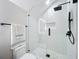 Modern bathroom shower with white subway tile and a frameless glass door at 217 W Bay St, Winter Garden, FL 34787
