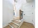 Elegant staircase with wooden steps and black metal railings, complemented by white walls and trim at 217 W Bay St, Winter Garden, FL 34787