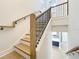 Elegant staircase with wooden treads, black metal balusters, and natural wood handrail at 217 W Bay St, Winter Garden, FL 34787