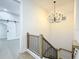Staircase with wooden handrail, chandelier, and a partial view of another room at 217 W Bay St, Winter Garden, FL 34787