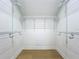 Bright walk-in closet features white walls and shelving, and hardwood floors at 217 W Bay St, Winter Garden, FL 34787