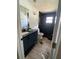 Modern bathroom featuring black tile, new fixtures, and a stylish vanity with a sleek mirror at 225 Ronnie Cir, Orlando, FL 32811