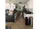 Bright kitchen featuring sleek black countertops and white cabinets at 225 Ronnie Cir, Orlando, FL 32811