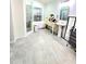 Bathroom with a walk-in shower, free-standing tub under window, vanity with sink, and gray tile flooring at 2346 Lily Pad Ln, Kissimmee, FL 34743