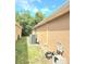 Side exterior view of the house with air conditioning, outdoor cable system and lawn at 2346 Lily Pad Ln, Kissimmee, FL 34743