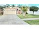 Charming single-story home with a well-maintained front yard and a two-car garage at 2346 Lily Pad Ln, Kissimmee, FL 34743