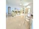 Bright living room featuring tile flooring and neutral paint, opening to the entry and a granite counter top bar at 2346 Lily Pad Ln, Kissimmee, FL 34743