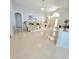 Bright living room featuring tile flooring and neutral paint, opening to the entry and a granite counter top bar at 2346 Lily Pad Ln, Kissimmee, FL 34743
