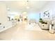 Bright living room featuring tile flooring, modern furniture, and a stylish chandelier at 2346 Lily Pad Ln, Kissimmee, FL 34743