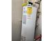 A water heater unit is installed in the corner of the garage at 2346 Lily Pad Ln, Kissimmee, FL 34743