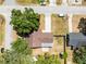This overhead aerial view shows the property, mature trees, storage shed and patio at 2401 8Th St, St Cloud, FL 34769