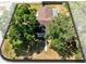 Aerial view of a cozy house with a well-maintained backyard surrounded by trees at 2401 8Th St, St Cloud, FL 34769