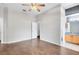 Bedroom featuring wood-look tile flooring leading to ensuite bathroom and large walk-in closet at 2401 8Th St, St Cloud, FL 34769
