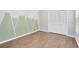 Bedroom with wood-look tile flooring, closet, and a window with natural light at 2401 8Th St, St Cloud, FL 34769