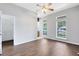 Spacious bedroom with wood-look tile flooring, ceiling fan, walk-in closet, and bright natural light at 2401 8Th St, St Cloud, FL 34769