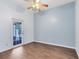 Bedroom with wood-look tile flooring and glass paneled door leading to the exterior at 2401 8Th St, St Cloud, FL 34769