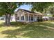 Beautiful house with front porch, mature trees, well-maintained lawn, and vinyl siding at 2401 8Th St, St Cloud, FL 34769