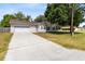 Charming single-story home with a well-maintained lawn and a spacious two car attached garage at 2401 8Th St, St Cloud, FL 34769