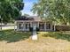 Charming home with a welcoming front porch, green grass, and mature trees at 2401 8Th St, St Cloud, FL 34769