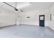 Spacious two car garage featuring a ceiling fan, automatic door opener, and epoxy floor at 2401 8Th St, St Cloud, FL 34769