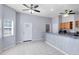 Bright kitchen featuring tile floors, bar-style counter, and a view of the laundry room at 2401 8Th St, St Cloud, FL 34769