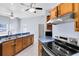 Eat-in kitchen featuring wood cabinets, stainless appliances and long countertop at 2401 8Th St, St Cloud, FL 34769
