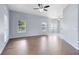 Spacious living room with wood floors, natural light, and a ceiling fan at 2401 8Th St, St Cloud, FL 34769