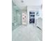 Bright bathroom with a glass shower, light grey floors, and an open closet at 247 Whispering Pines Way, Davenport, FL 33837