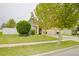 Manicured front lawn of a single-Gathering home with a sidewalk and mature shade trees at 247 Whispering Pines Way, Davenport, FL 33837