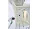 Modern walk-in shower featuring rainfall showerhead, sleek design, and built-in seating at 247 Whispering Pines Way, Davenport, FL 33837