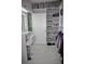 Well-designed walk-in closet with vanity, shelving, and ample space for clothing and accessories at 247 Whispering Pines Way, Davenport, FL 33837