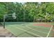 Full basketball court for practice or recreation surrounded by a wooded area at 2632 Emerald Island Blvd, Kissimmee, FL 34747