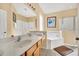 Bathroom featuring a double sink vanity, large tub, and glass enclosed shower at 2632 Emerald Island Blvd, Kissimmee, FL 34747