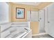 Bathroom featuring a large tub, glass enclosed shower, and tiled floors at 2632 Emerald Island Blvd, Kissimmee, FL 34747