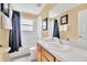 Bright bathroom featuring a sink, mirror, toilet, and shower-tub combo at 2632 Emerald Island Blvd, Kissimmee, FL 34747
