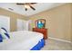 Bedroom featuring a fan, comfortable bed, and dresser with a TV at 2632 Emerald Island Blvd, Kissimmee, FL 34747