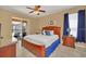 Bedroom featuring a wood bed frame, night stand and sliding door leading to screened in patio at 2632 Emerald Island Blvd, Kissimmee, FL 34747