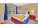Well-lit bedroom with a large window, comfortable bed, and two nightstands at 2632 Emerald Island Blvd, Kissimmee, FL 34747