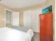 Comfortable bedroom featuring a large closet, neutral decor, and easy access to the hallway at 2632 Emerald Island Blvd, Kissimmee, FL 34747