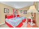 Bright bedroom featuring two beds with colorful linens and decorative wall art at 2632 Emerald Island Blvd, Kissimmee, FL 34747