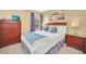 Inviting bedroom with a queen-size bed, dresser, and ample natural light, creating a relaxing atmosphere at 2632 Emerald Island Blvd, Kissimmee, FL 34747