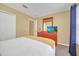 Bedroom featuring a comfortable bed, closet, and dresser with a TV at 2632 Emerald Island Blvd, Kissimmee, FL 34747