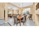 Formal dining room with wood table, chandelier, and view into the adjacent living room space at 2632 Emerald Island Blvd, Kissimmee, FL 34747