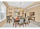 Formal dining room featuring wood table, chandelier, built in storage and display, and large window at 2632 Emerald Island Blvd, Kissimmee, FL 34747