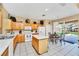 Bright kitchen features white appliances, tile floors, island, and dining table with sliding glass doors at 2632 Emerald Island Blvd, Kissimmee, FL 34747